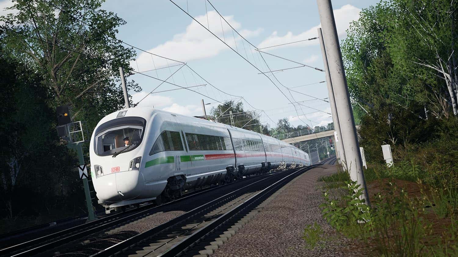High-speed train traveling on railway tracks with overhead electric lines, surrounded by greenery, i.