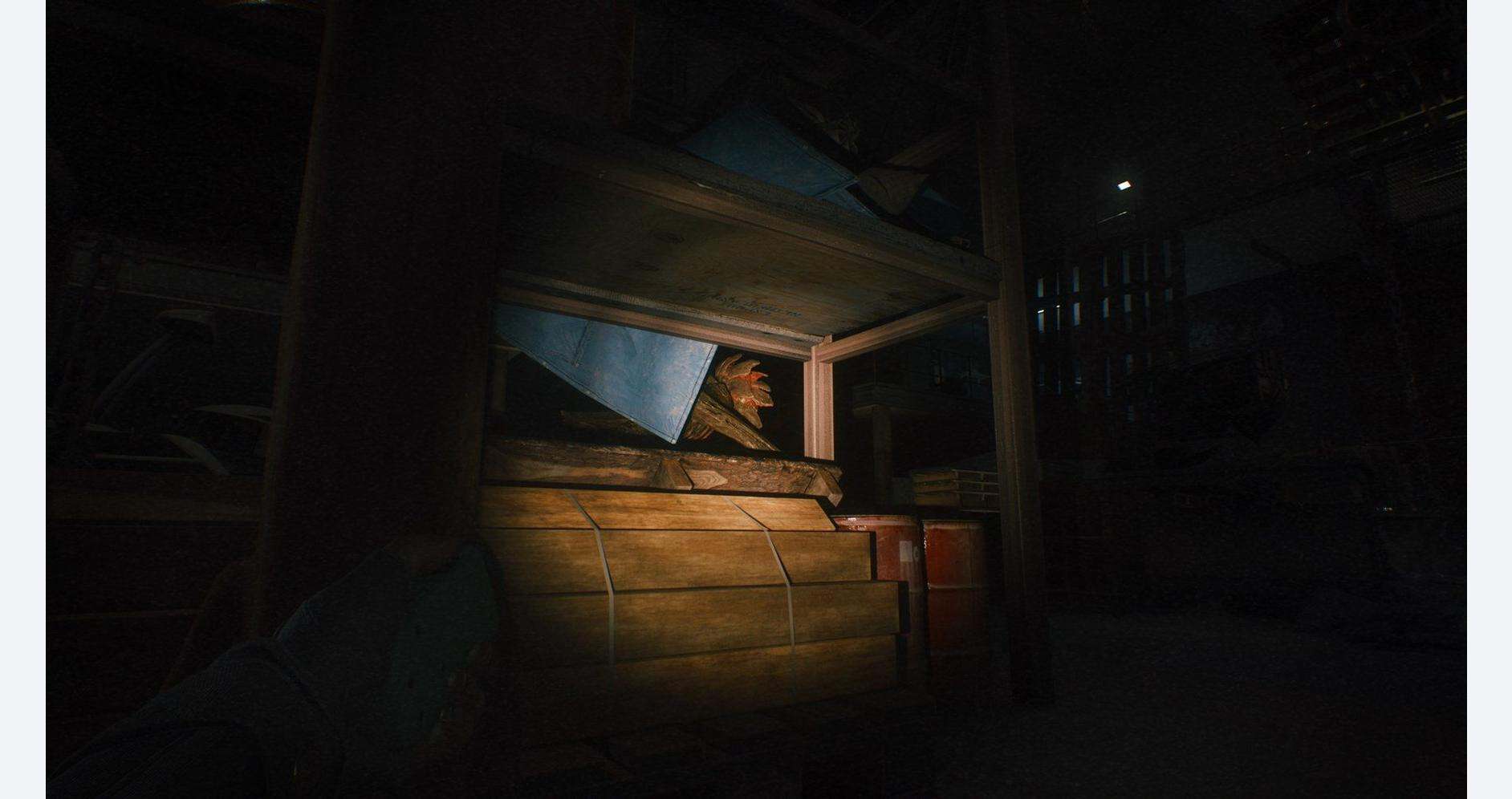 Dimly lit scene of a wooden bed and desk in a quiet, dark room.