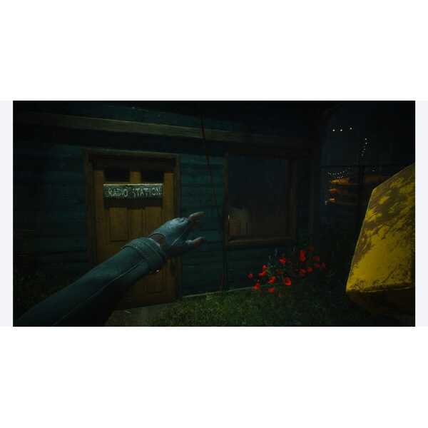 First-person view of a hand reaching towards a radio station sign outside a wooden building at night.