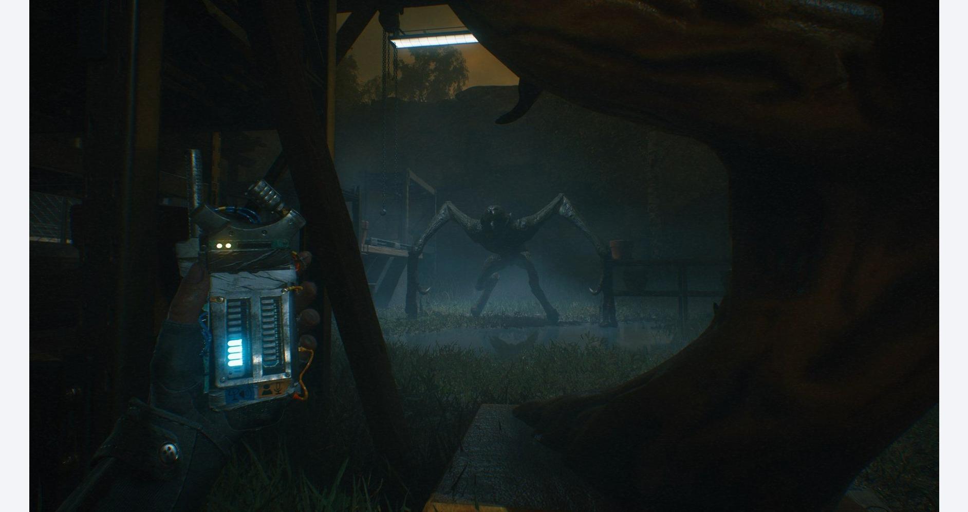 Player holding a device facing a giant spider in a dark, eerie environment.