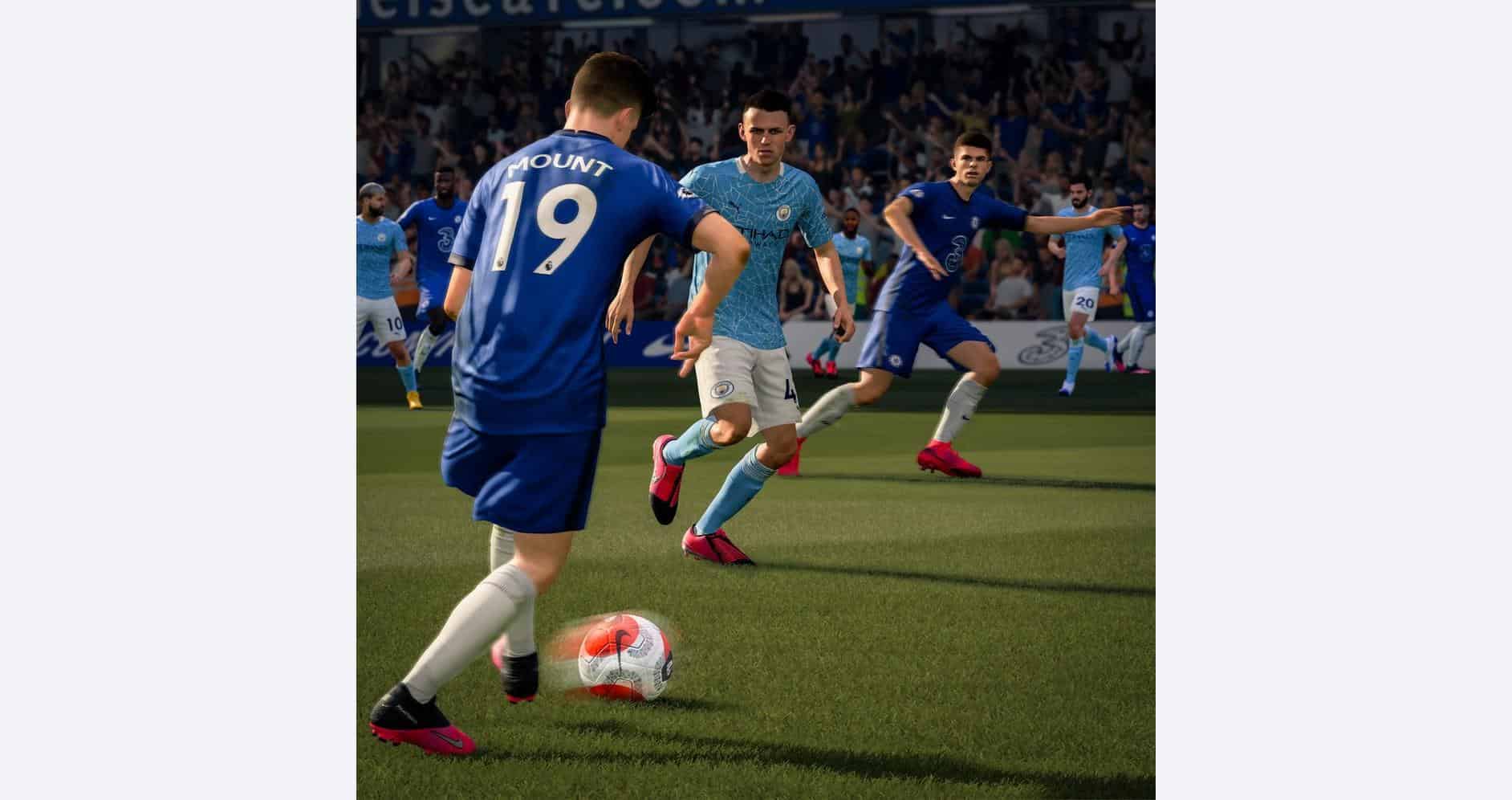 A soccer match with players in blue and white jerseys competing on the field.