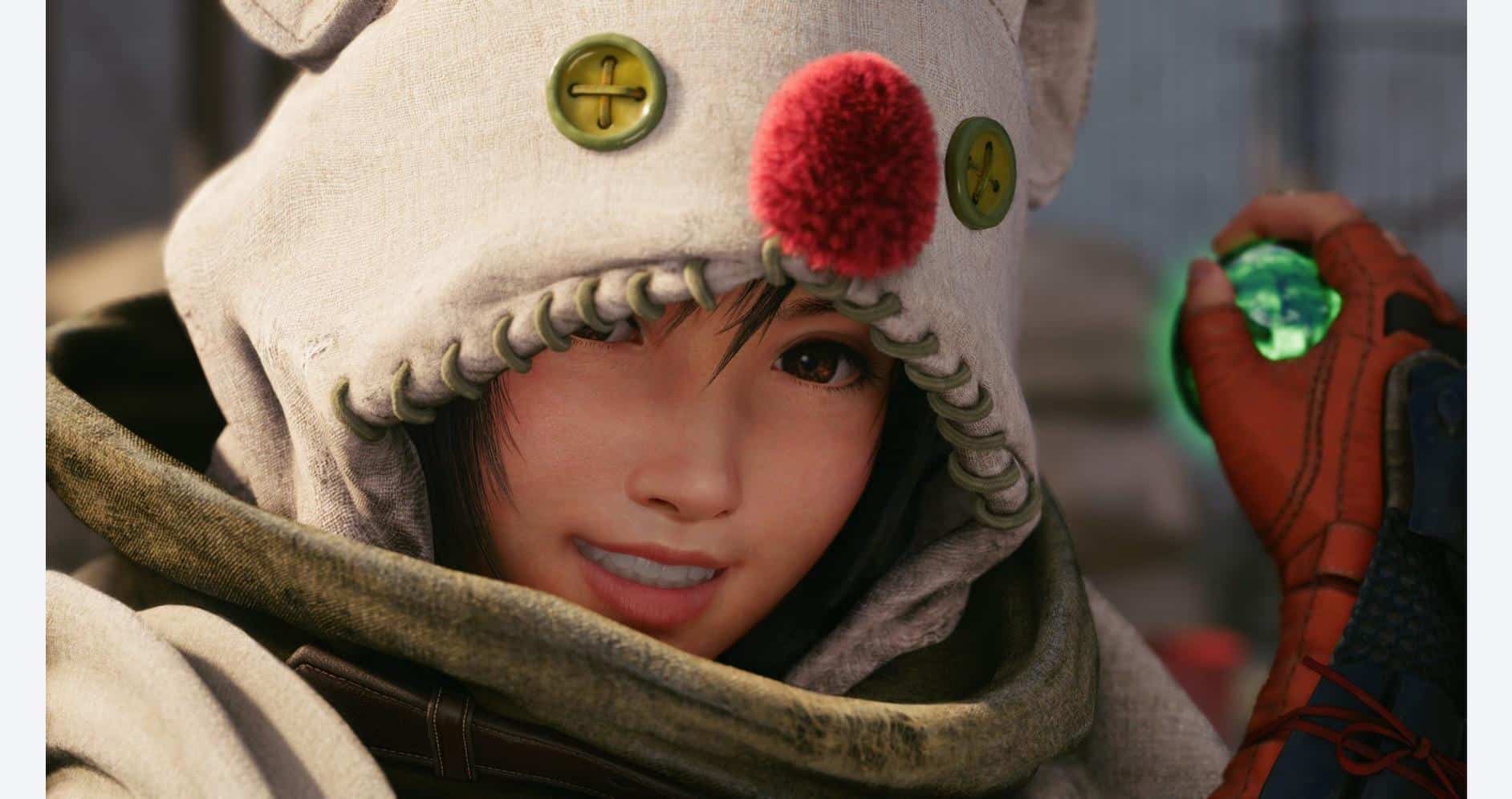 Woman in a cozy hoodie with a red pom-pom, holding a gaming device.