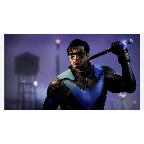 A man in futuristic armor holding a glowing weapon in a dark, urban environment.