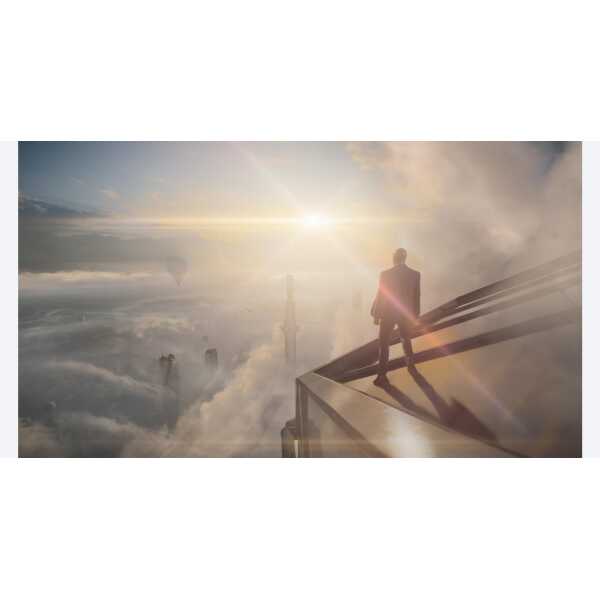 A man standing on a glass ledge overlooking a city skyline at sunrise, symbolizing ambition and succ.