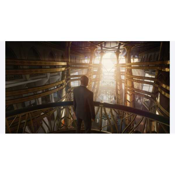A man standing inside a futuristic, illuminated architectural structure with golden accents.