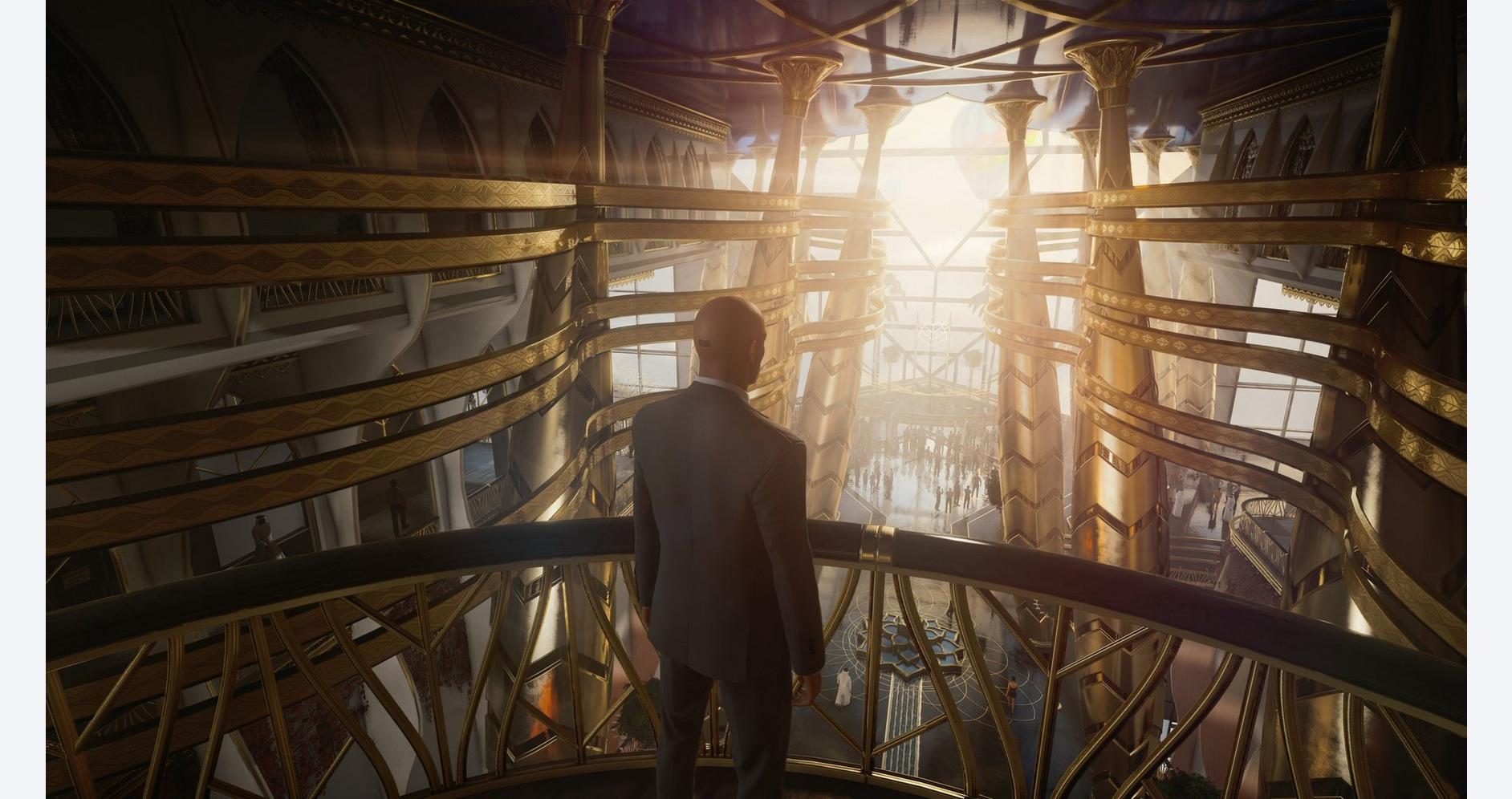 A man standing inside a futuristic, illuminated architectural structure with golden accents.