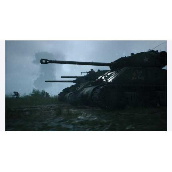 M1 Abrams tanks in a military training exercise during overcast weather.