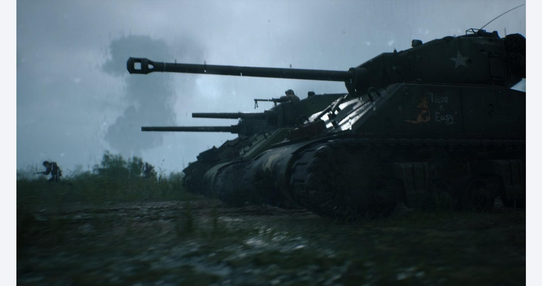 M1 Abrams tanks in a military training exercise during overcast weather.