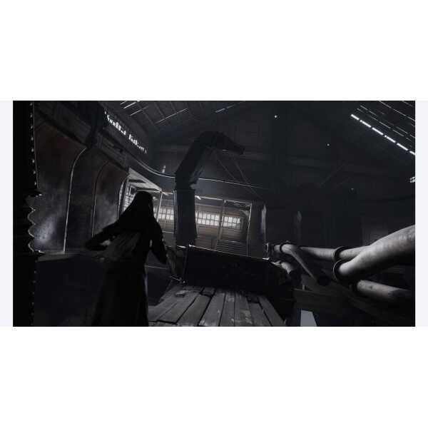 A woman in a dark industrial setting with machinery and metal structures.
