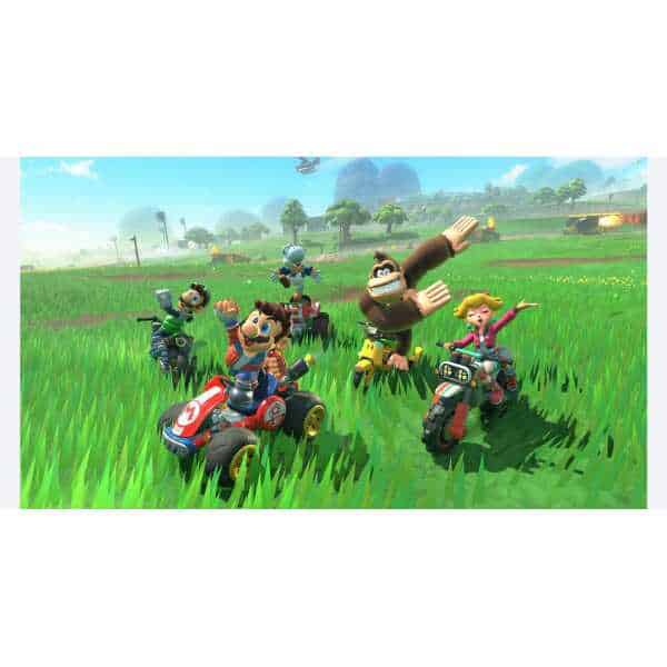 Mario Kart characters racing on vibrant green track in a colorful game world.