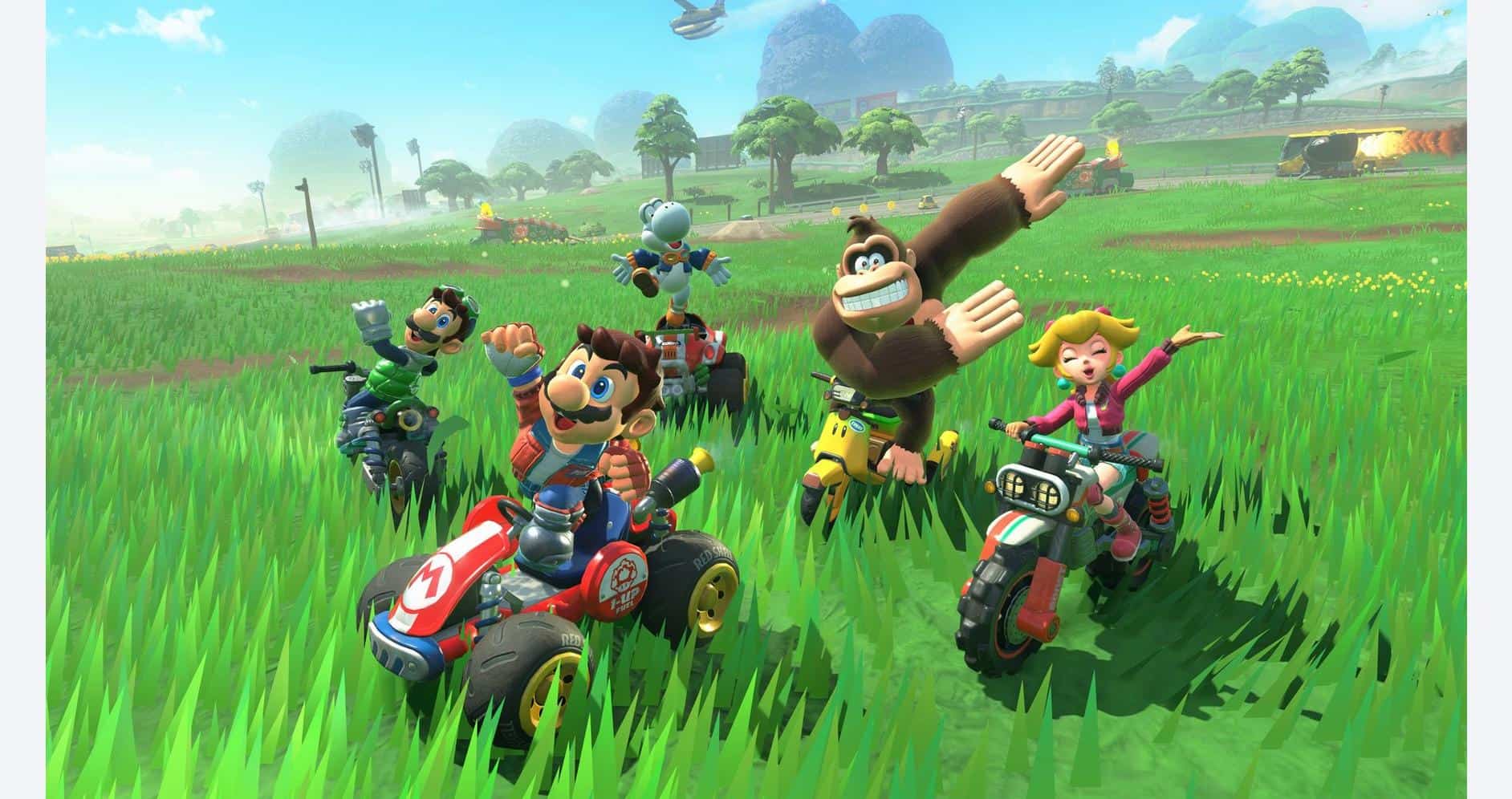 Mario Kart characters racing on vibrant green track in a colorful game world.