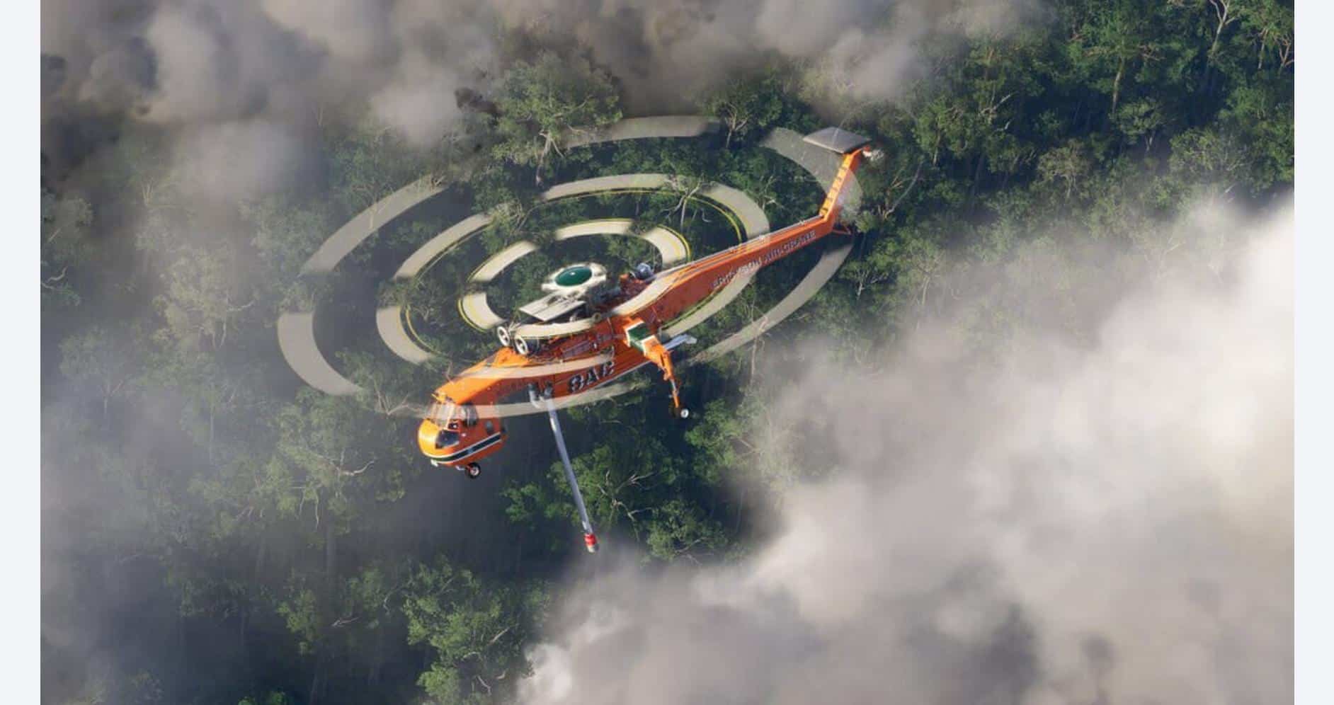 Helicopter spraying water over forest fire for firefighting efforts.