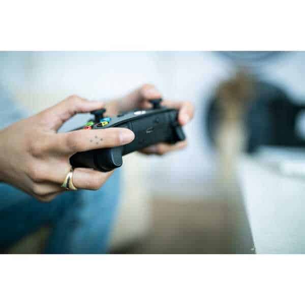 Person holding Xbox Series X Wireless Controller - Carbon Black.