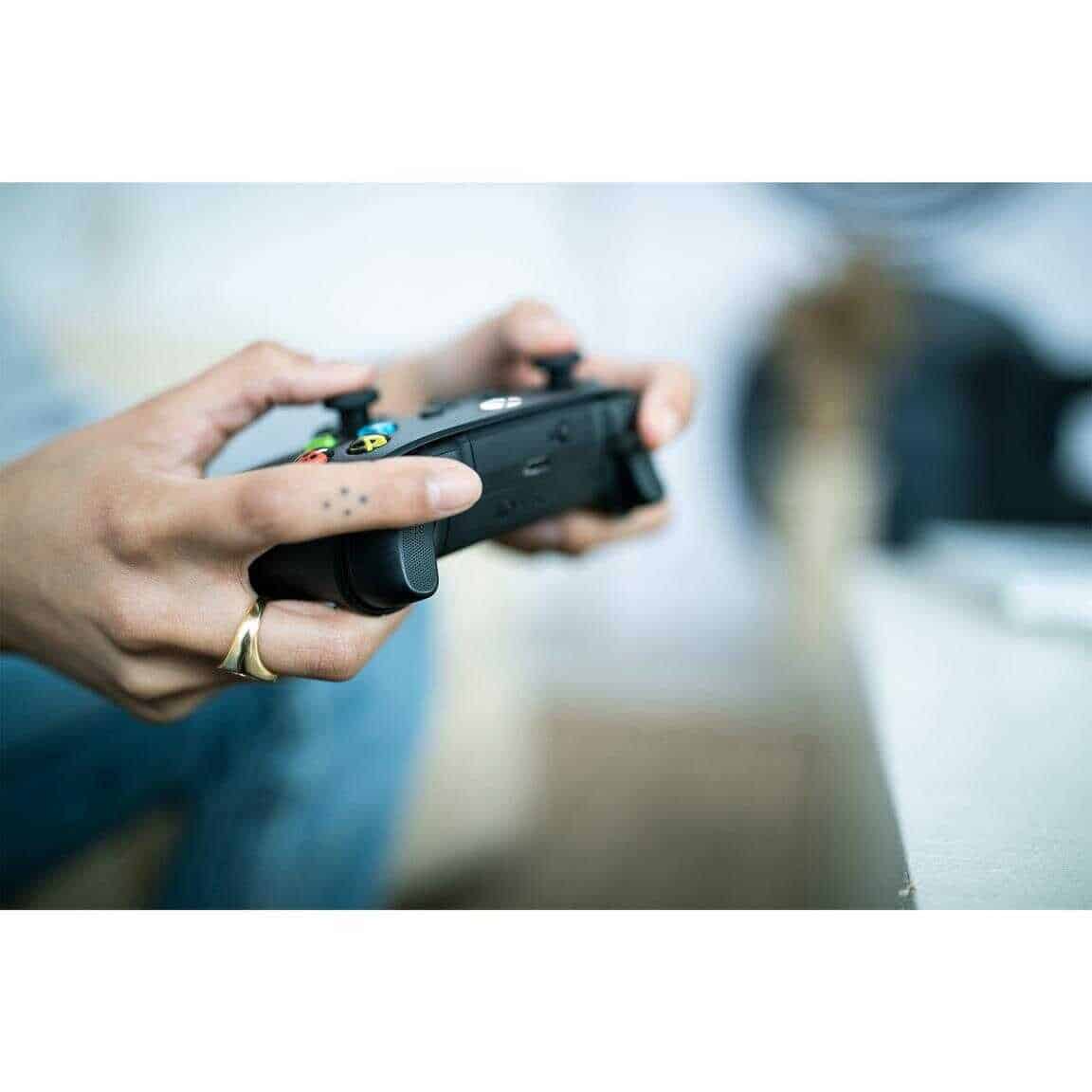 Person holding Xbox Series X Wireless Controller - Carbon Black.