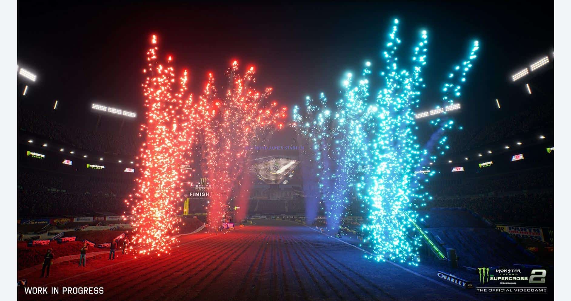 Fireworks explode in red and blue colors during Monster Energy Supercross event.