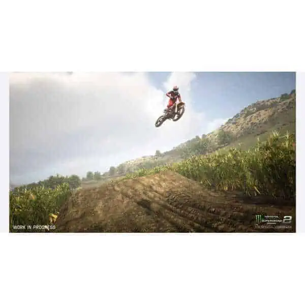 Motocross rider jumping over dirt track in Monster Energy Supercross game.