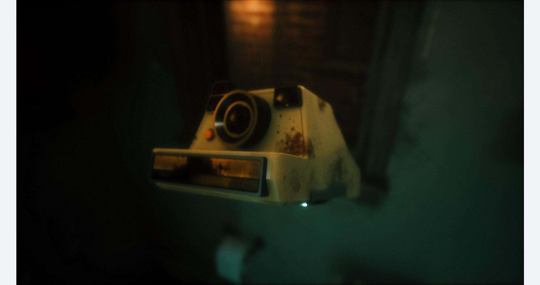 A vintage Polaroid camera with a worn, nostalgic look on a dark background.