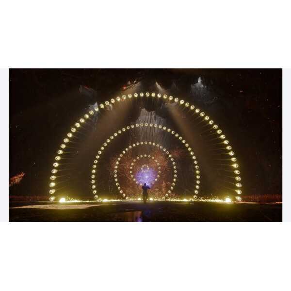 Light tunnel with circular LED displays at night.