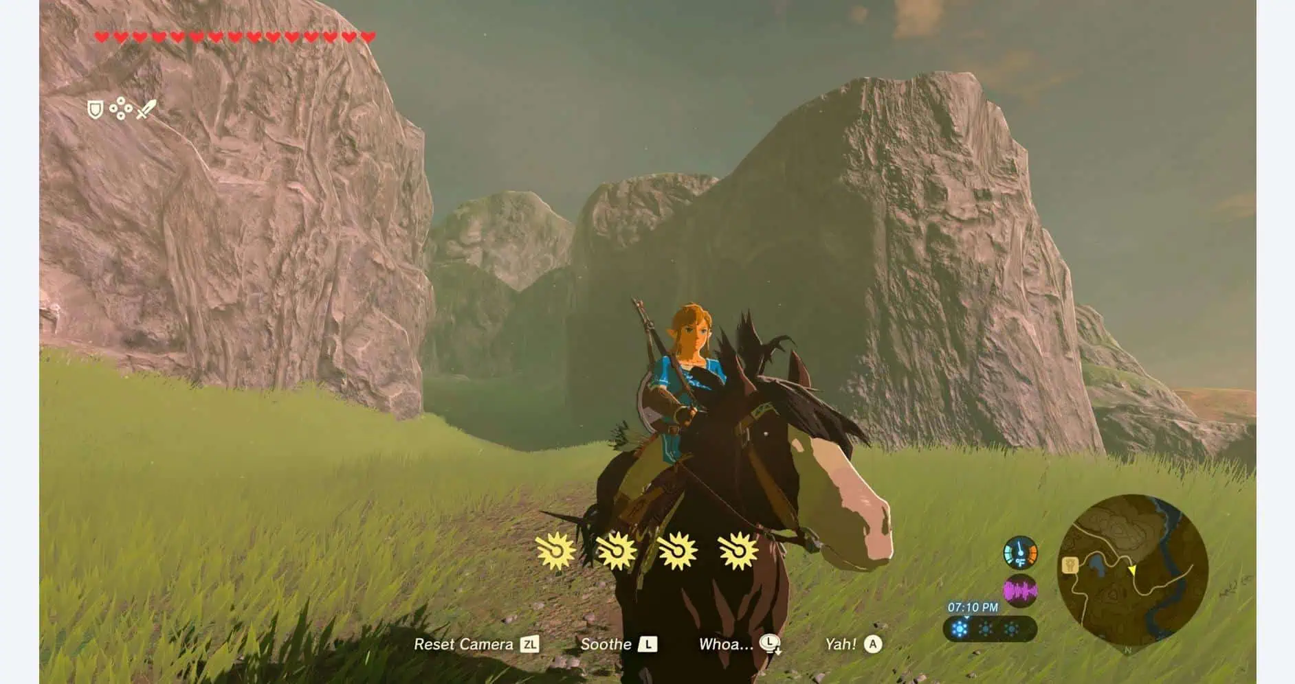 Hero riding a horse in lush green landscape with mountains in the background.