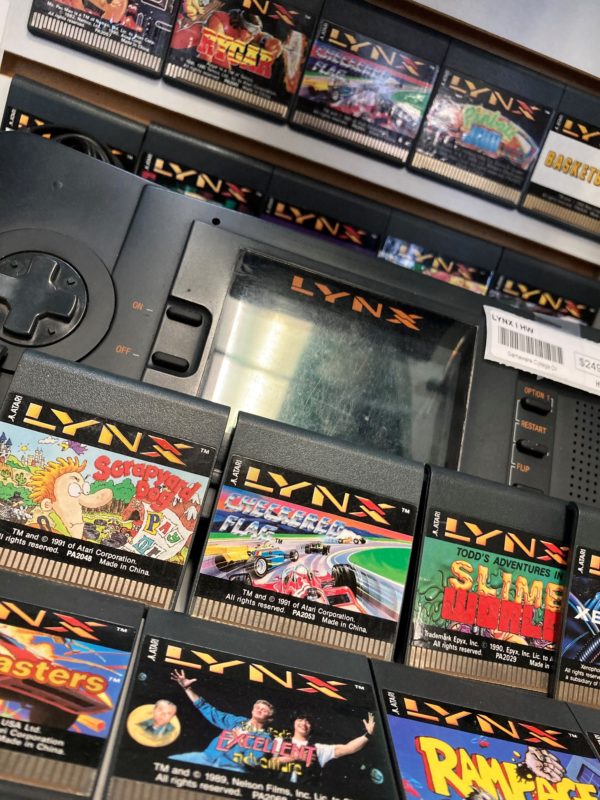 a photo of a Lynx console with games surrounding it