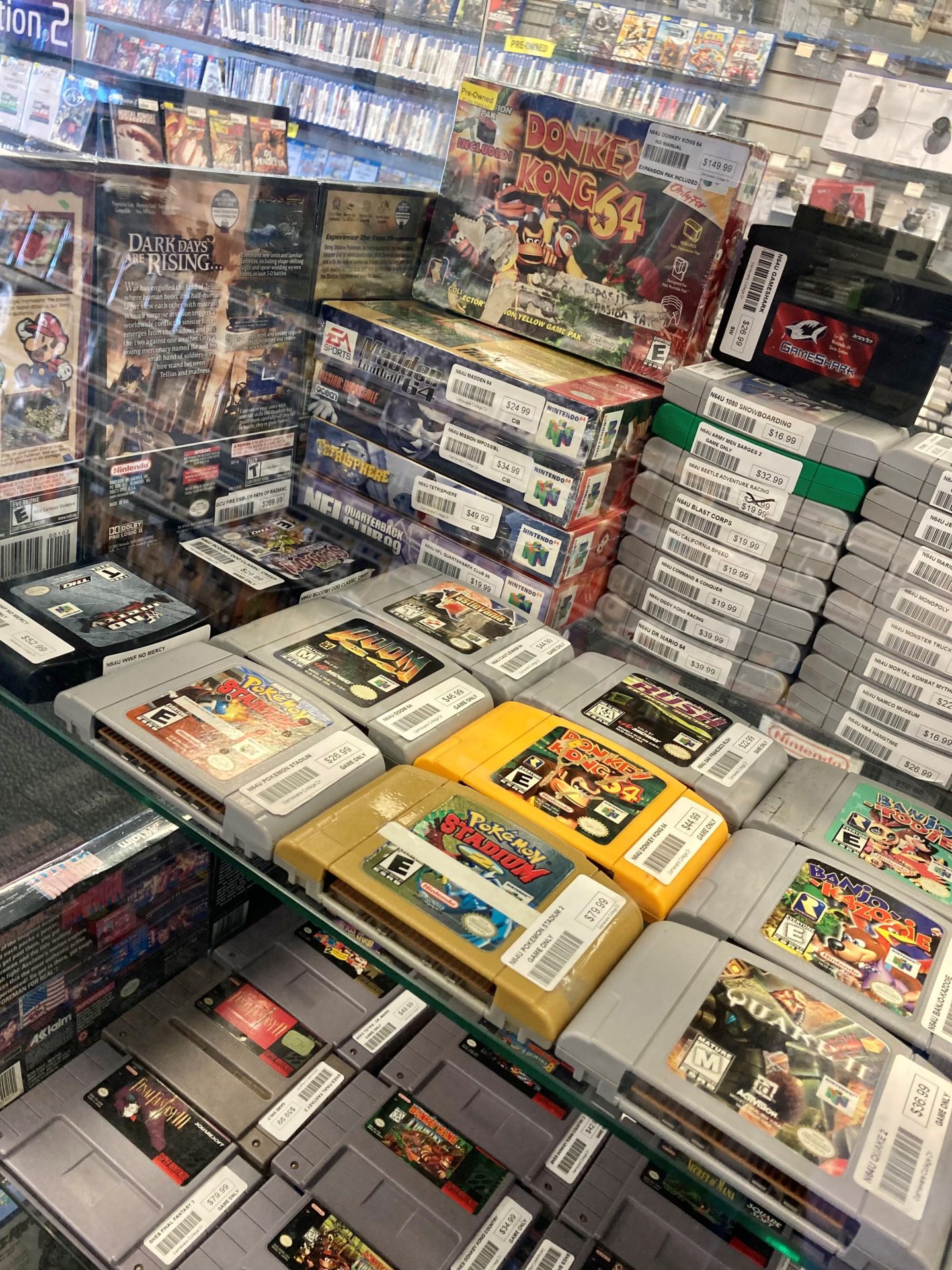 a display case showing several Nintendo 64 cartridges, including some with boxes